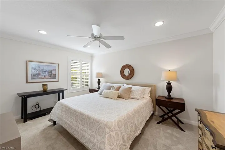 Bedroom featuring light carpet, recessed lighting, and ornamental molding