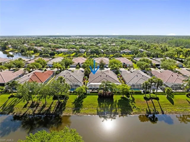 Birds eye view of property featuring a water view and a residential view