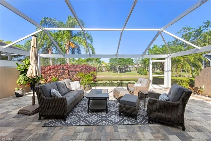 View of patio with an outdoor living space and glass enclosure
