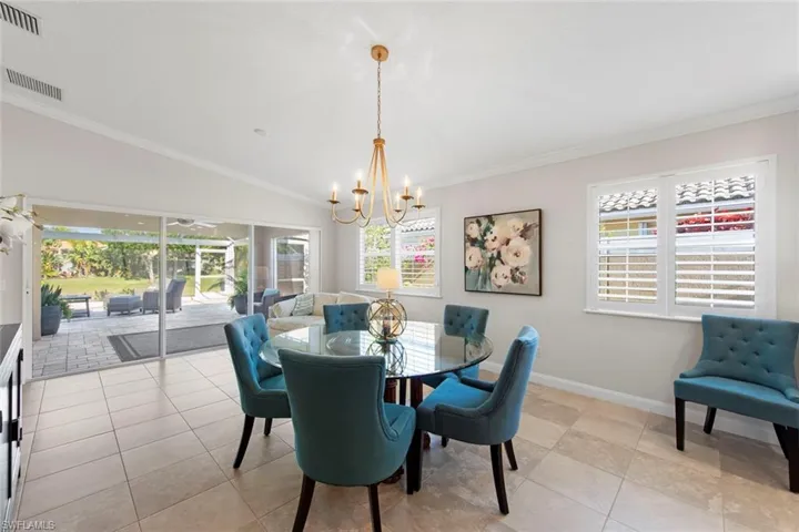 Dining room featuring an inviting chandelier, visible vents, and plenty of natural light