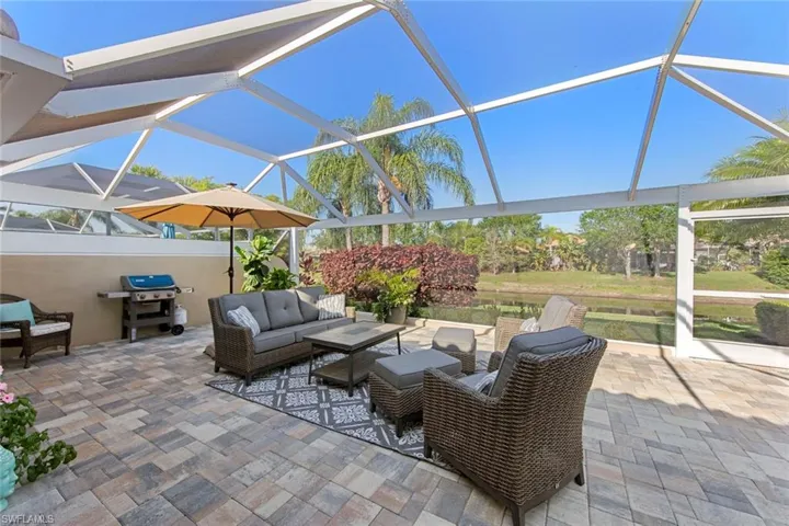 View of patio / terrace featuring glass enclosure, area for grilling, and an outdoor living space