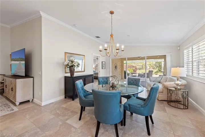 Dining area featuring visible vents, baseboards, a chandelier, and crown molding