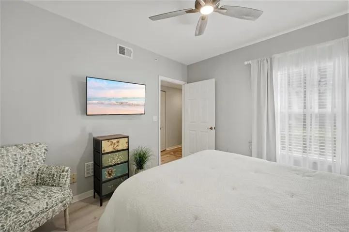 Bedroom with light wood-style floors and a ceiling fan