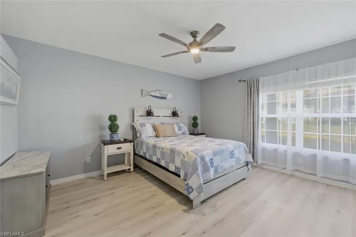 Bedroom with light wood-style flooring and ceiling fan