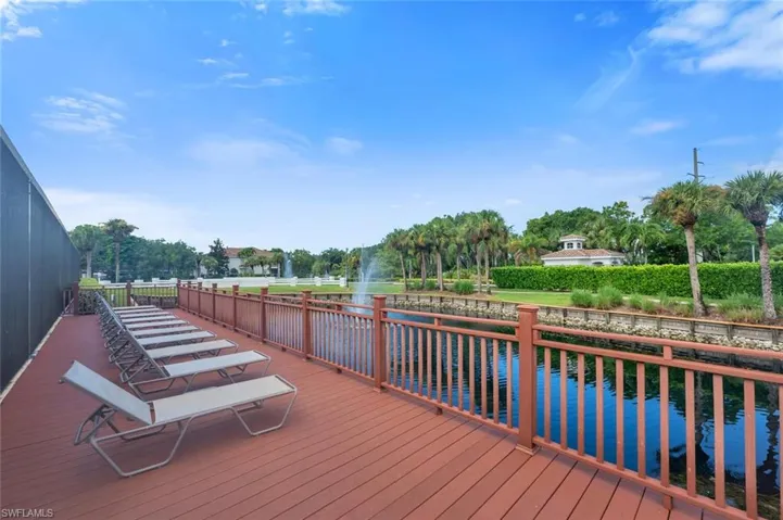 Wooden deck with a water view and view of scattered trees