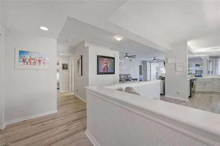 Hall with light wood-style flooring and recessed lighting
