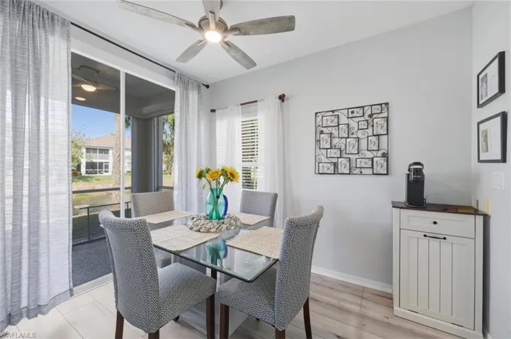 Dining room with light wood-style flooring and a ceiling fan