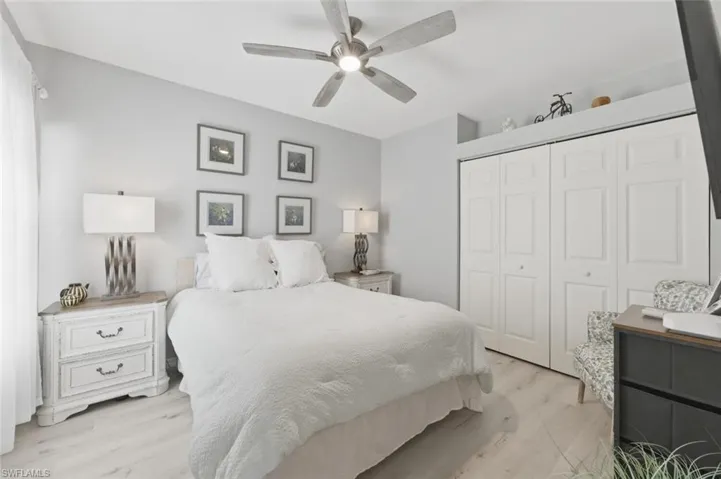 Bedroom featuring light wood-style flooring, a closet, and ceiling fan