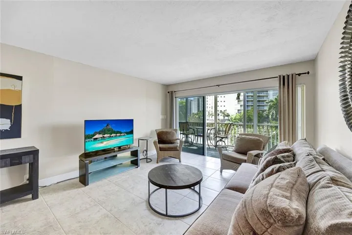 Living area with tile patterned floors and a textured ceiling