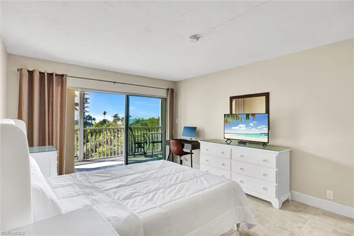Bedroom with access to exterior and light tile patterned floors