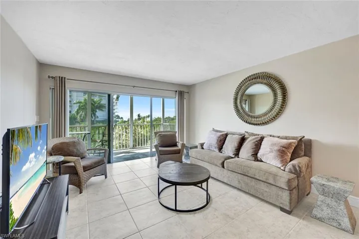 Living area featuring light tile patterned floors and a textured ceiling