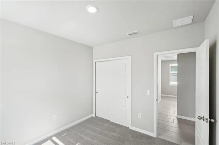 Unfurnished bedroom with baseboards and a closet