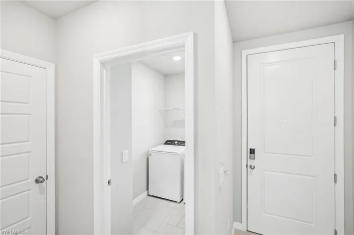Washroom featuring washer / clothes dryer and baseboards