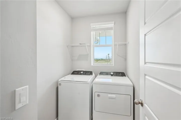 Washroom featuring washer and clothes dryer