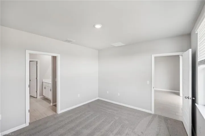 Unfurnished room with light colored carpet, baseboards, and recessed lighting