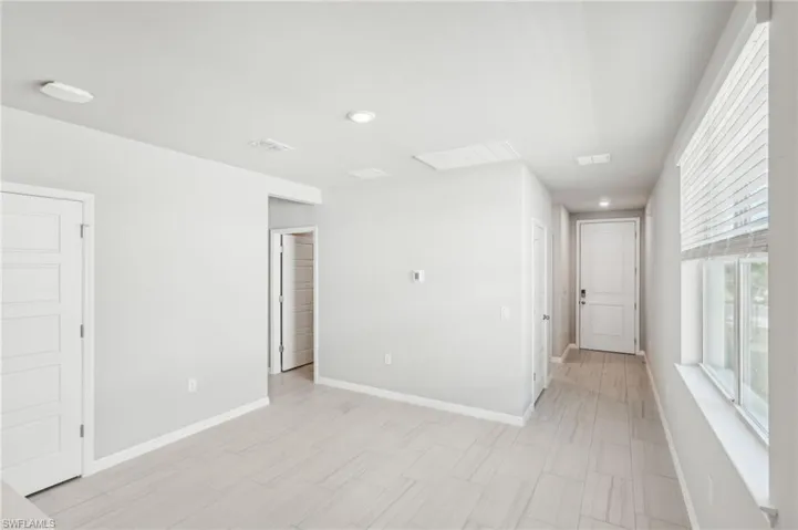 Spare room with baseboards and recessed lighting