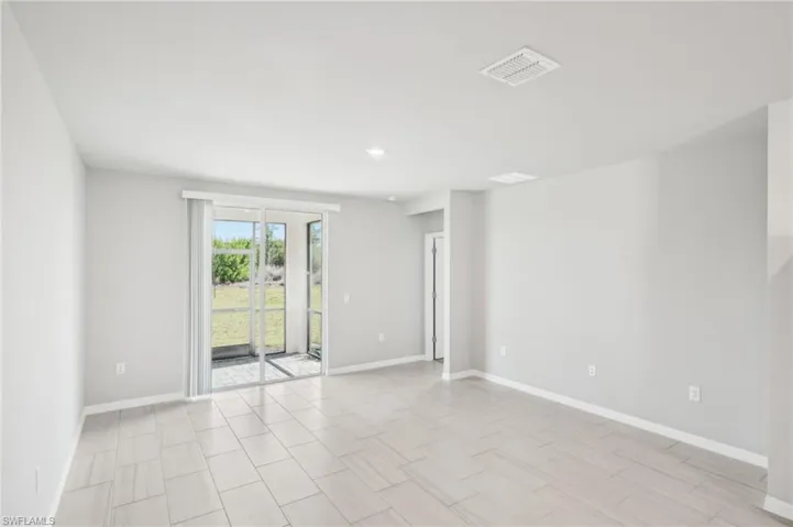 Empty room featuring baseboards and recessed lighting