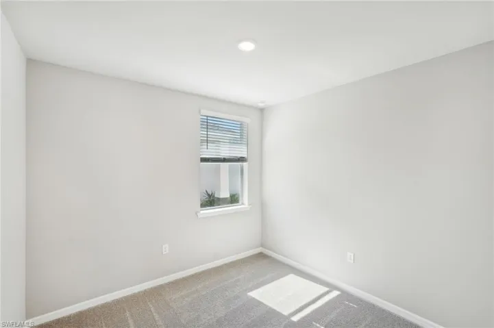 Unfurnished room with carpet flooring and baseboards