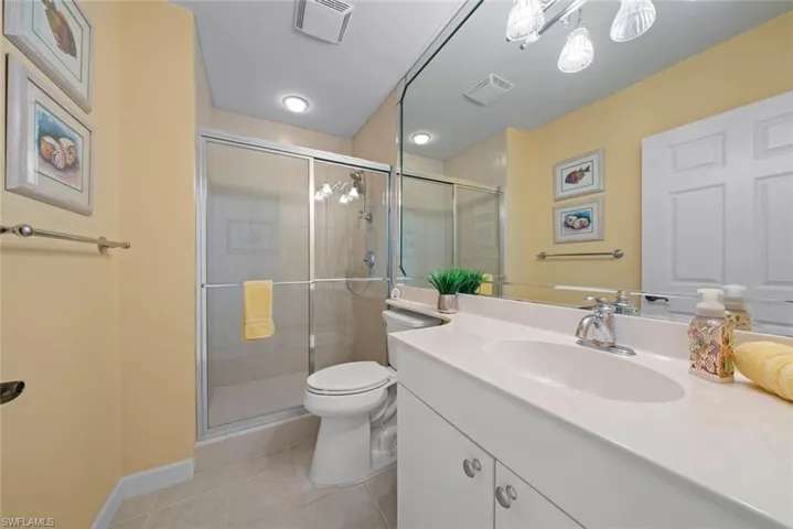 Full bathroom featuring a stall shower, visible vents, and tile patterned flooring