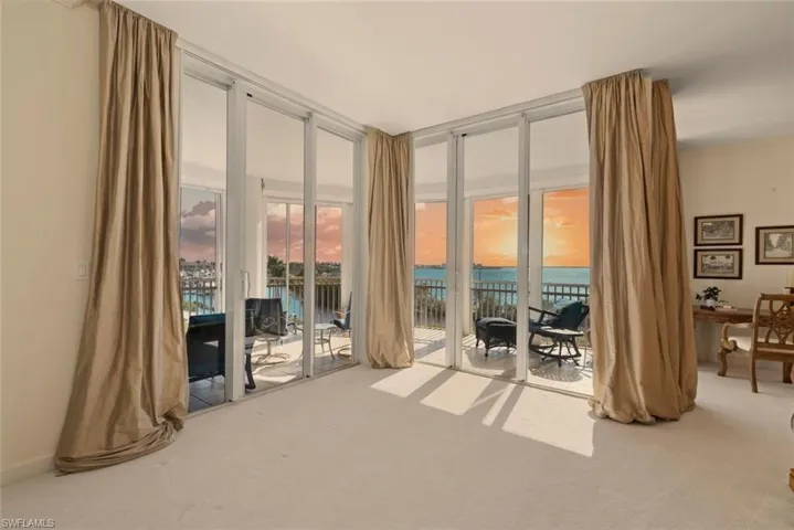 Sitting room featuring expansive windows and carpet flooring