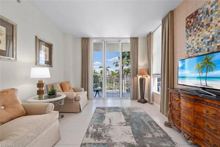 Living area featuring light tile patterned floors and a wall of windows