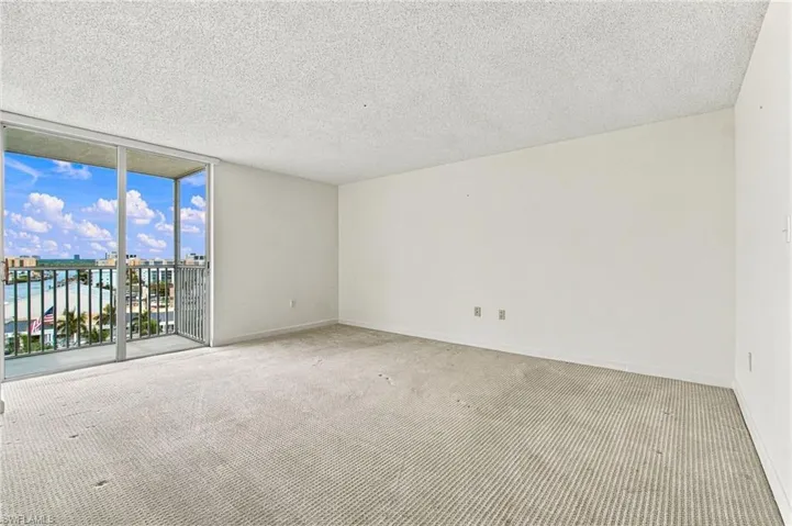 Sliding glass doors opening to a balcony with metal railings