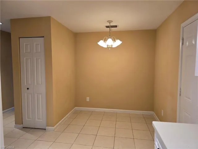 Breakfast area featuring hanging lights and light tile patterned floors