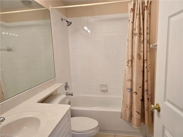 Bathroom featuring vanity and shower / bath combo with shower curtain