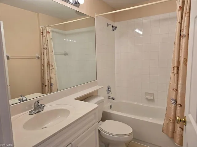 Full bath featuring vanity and shower / bathtub combination with curtain