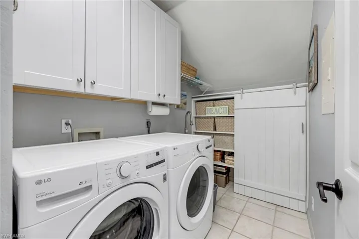 Newer appliances in cute laundry room