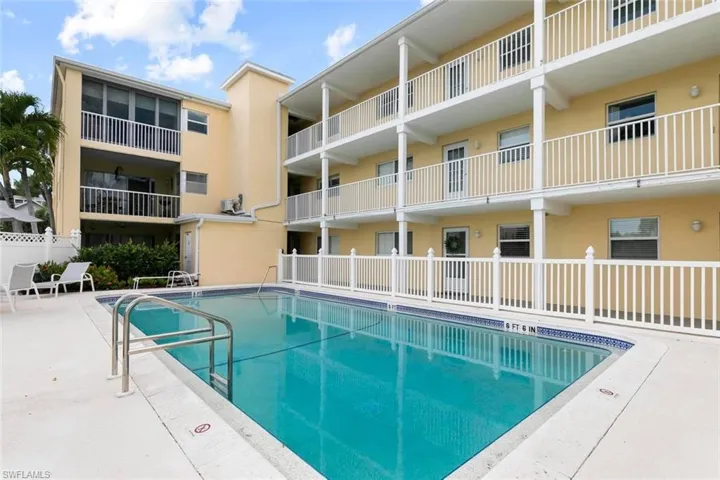 Community pool featuring a patio
