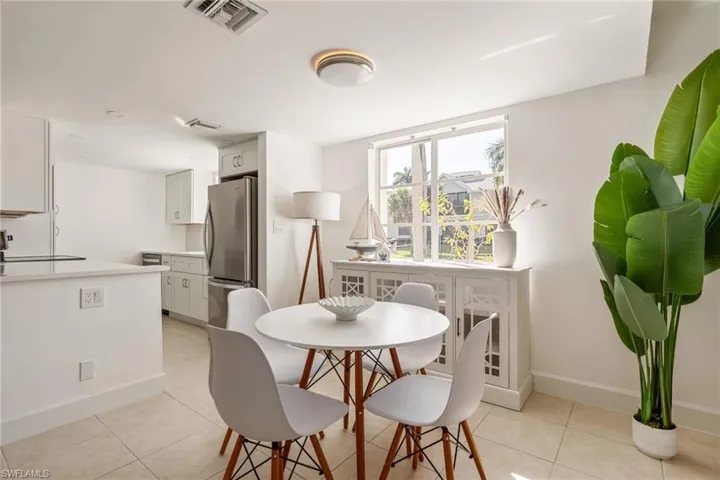 Dining area featuring light tile patterned floors and baseboards