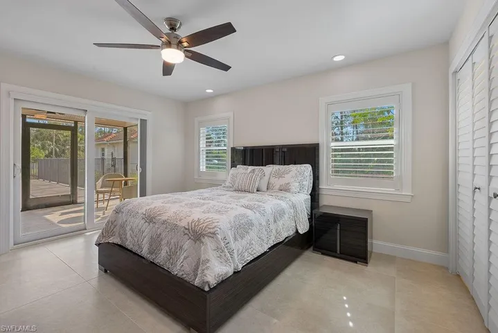 Bedroom featuring multiple windows, access to exterior, ceiling fan, and recessed lighting