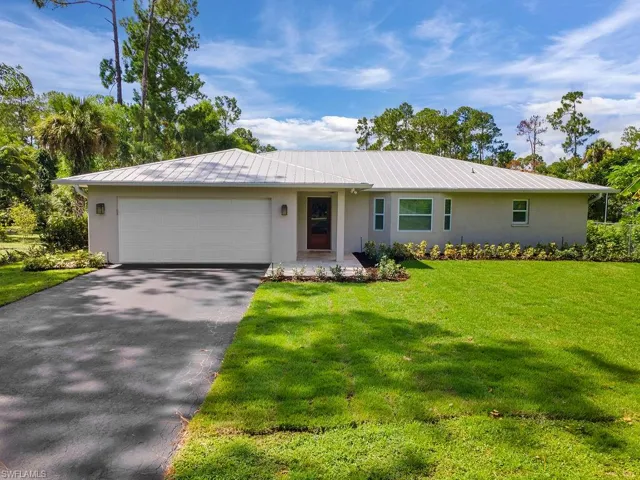 Ranch-style home featuring stucco siding, asphalt driveway, and a garage