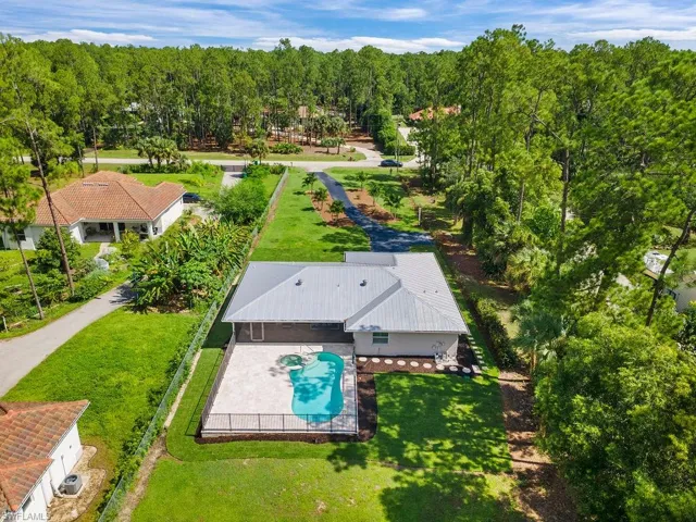 View of subject property with a pool