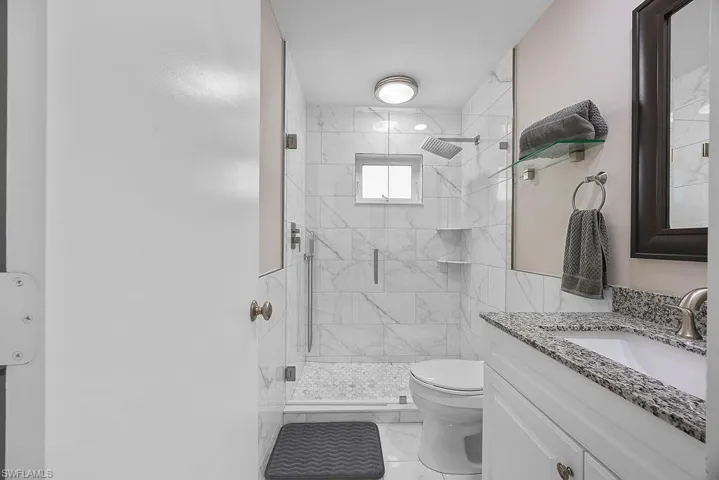 Bathroom with vanity and a shower stall