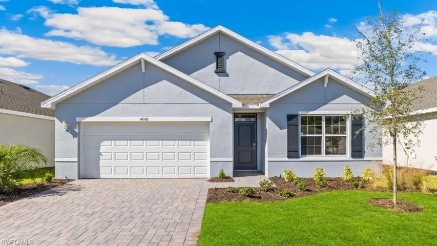 Model home. Single story home with stucco siding, decorative driveway, a front lawn, and a garage