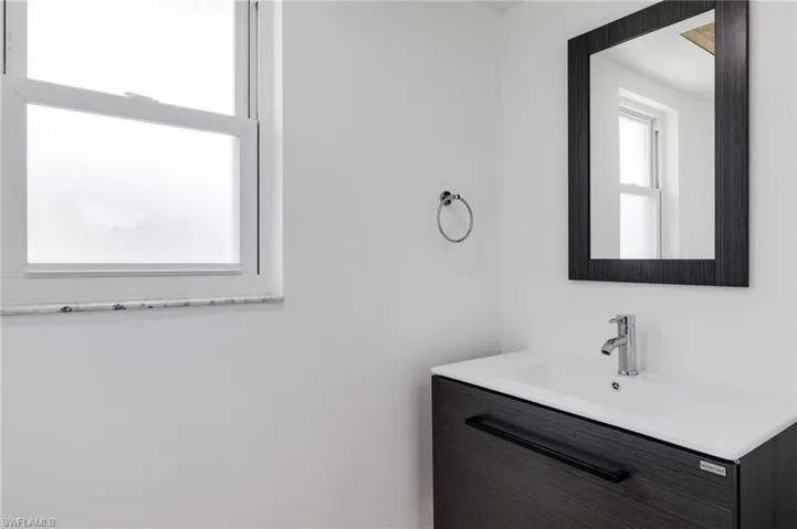 Bathroom with a wealth of natural light and vanity