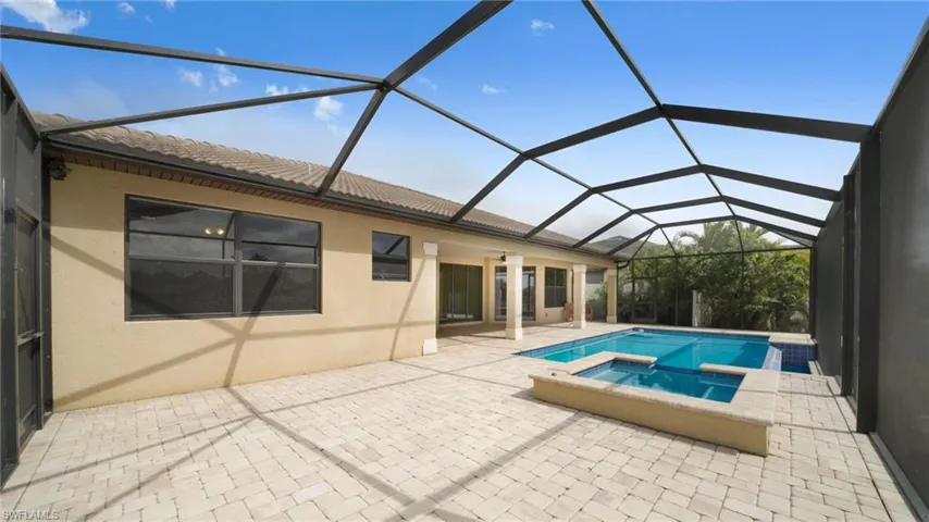 Pool with spillover spa and huge screened deck.