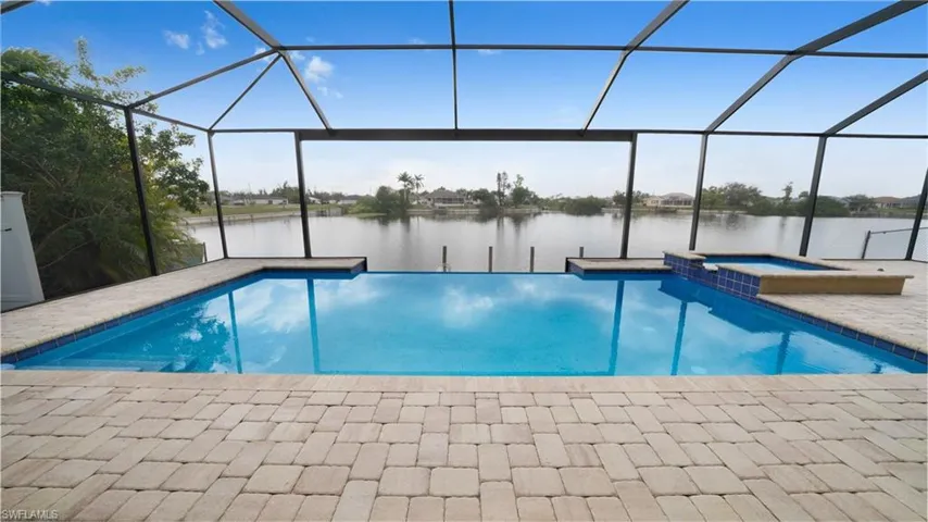Stunning infinity pool with southern exposure looking out through the picture screen onto the serene beauty of the lake.