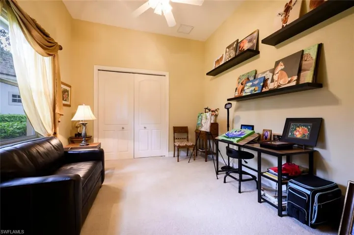 Guest Bedroom currently being used as an Art Studio. The closet is organized with a desk area