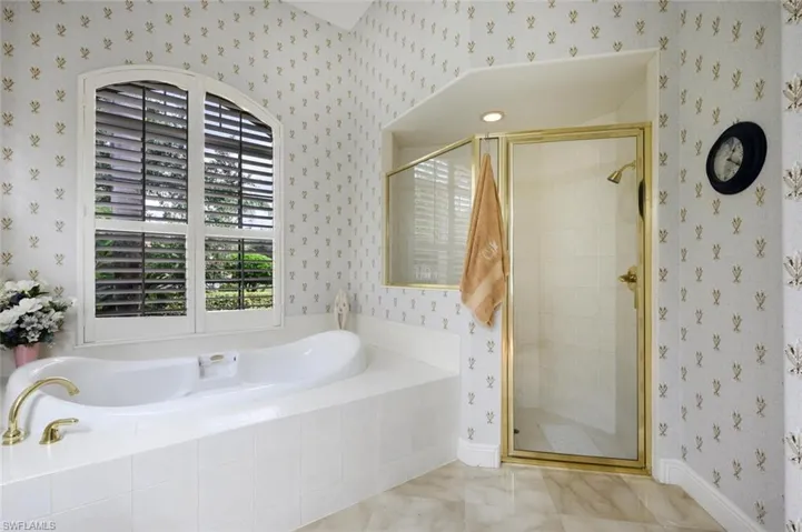 Primary Bathroom with separate tub and walk in tile shower