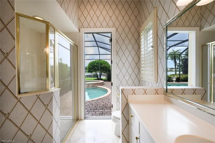 One of the Primary Bedroom ensuite with walk in tile shower and access to the Pool Area