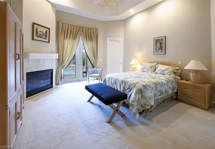 Primary Bedroom with French Doors to the Covered Lana and Built in  fireplace