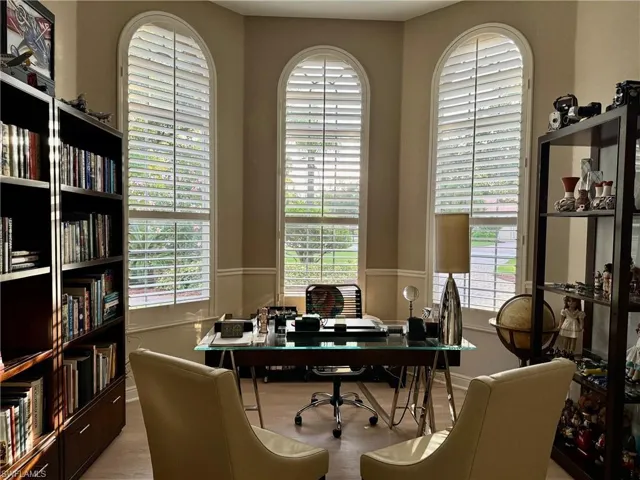 Well designed spacious office with wood floors that could be used as additional sleeping space
