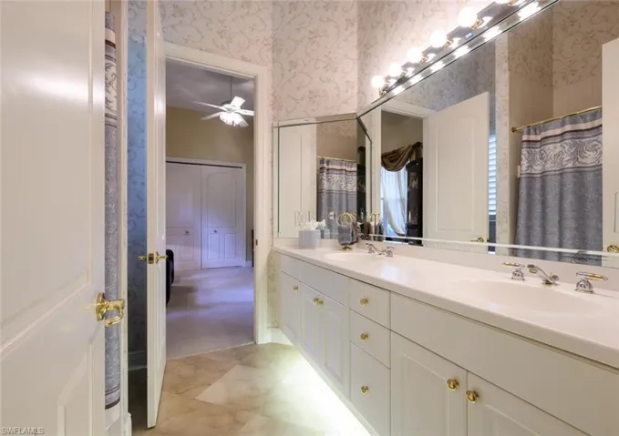 Shared Jack and Jill Bathroom with double sinks and tub/shower combo