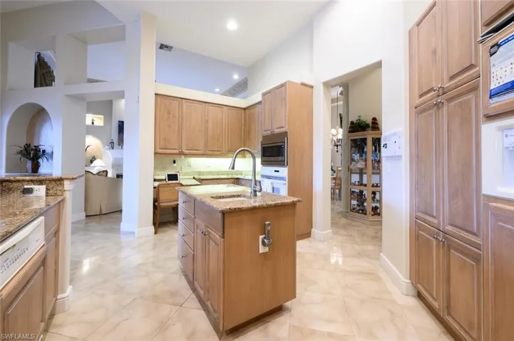 Kitchen with granite counter tops, Built in Microwave and oven, Paneled refrigerator and built in desk area