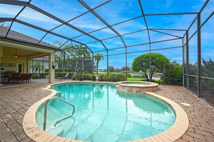 View of pool and Spa with screened enclosure and Lake Views