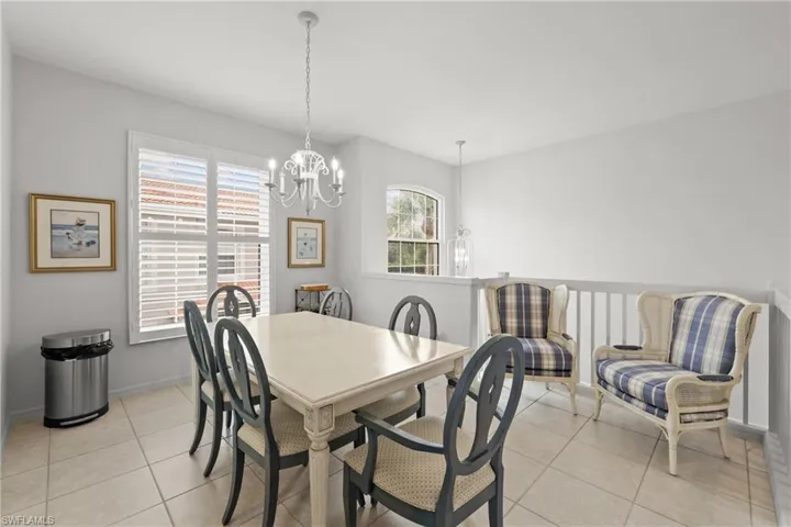 Dining room with an inviting chandelier and light tile patterned floors