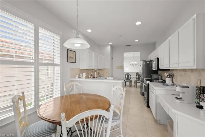 Kitchen featuring white cabinets, stainless steel appliances, and plenty of natural light